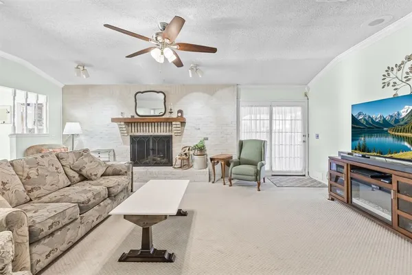 a living room with furniture a fireplace and a flat screen tv