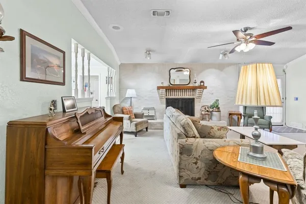 a living room with furniture a fireplace and a flat screen tv