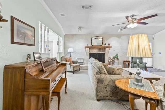 a living room with furniture a fireplace and a flat screen tv