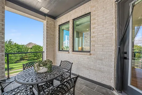 a view of a porch with furniture and floor to ceiling window