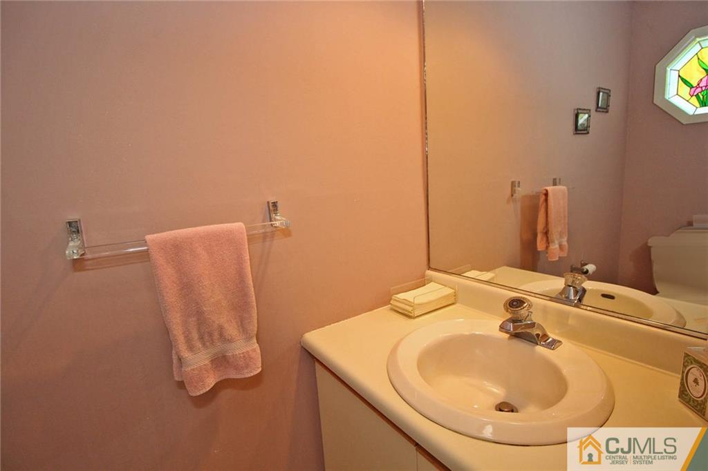 4004 Springbrook Drive Edison, NJ 08820 - Photo 13 of 25 a bathroom with a sink and mirror