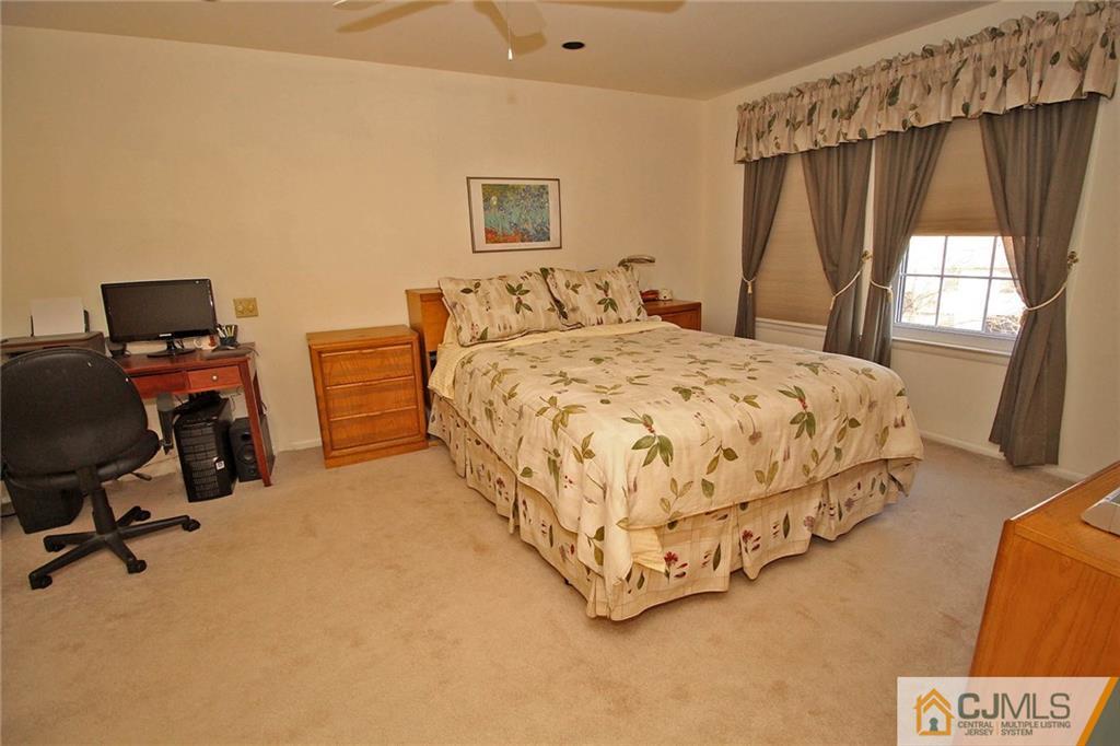 4004 Springbrook Drive Edison, NJ 08820 - Photo 14 of 25 a bedroom with a bed and a desk