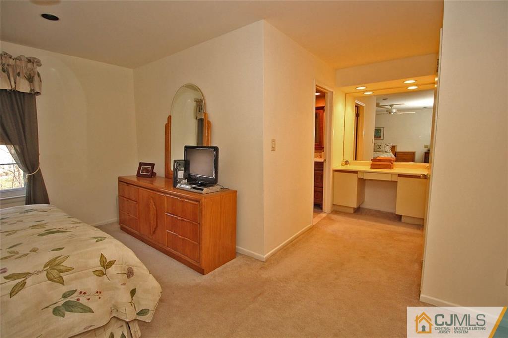 4004 Springbrook Drive Edison, NJ 08820 - Photo 15 of 25 a bedroom with a bed and a flat screen tv