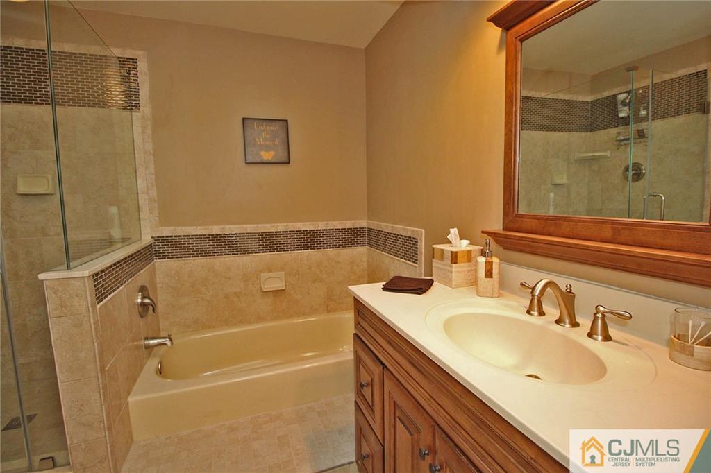 4004 Springbrook Drive Edison, NJ 08820 - Photo 16 of 25 a bathroom with a sink and a mirror