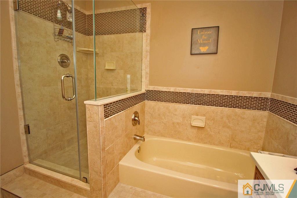 4004 Springbrook Drive Edison, NJ 08820 - Photo 17 of 25 a bathroom with a shower and a bath tub