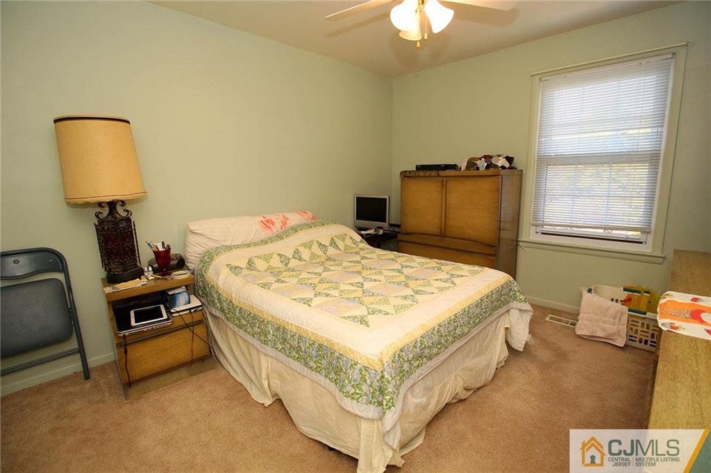 4004 Springbrook Drive Edison, NJ 08820 - Photo 18 of 25 a bedroom with a bed and a chandelier