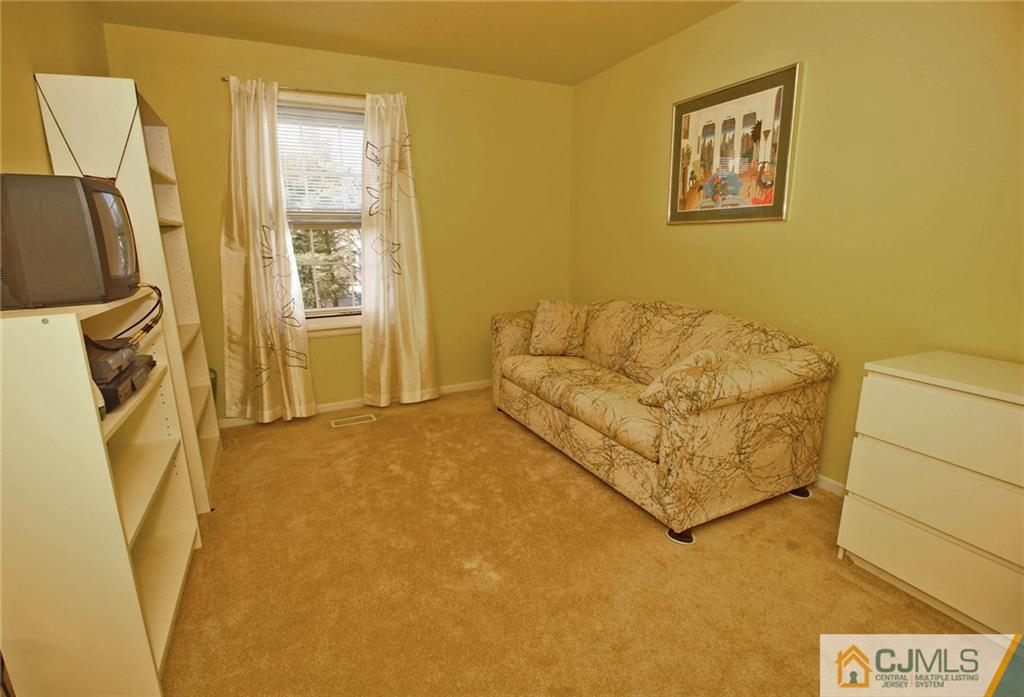 4004 Springbrook Drive Edison, NJ 08820 - Photo 19 of 25 a living room with a couch and a flat screen tv