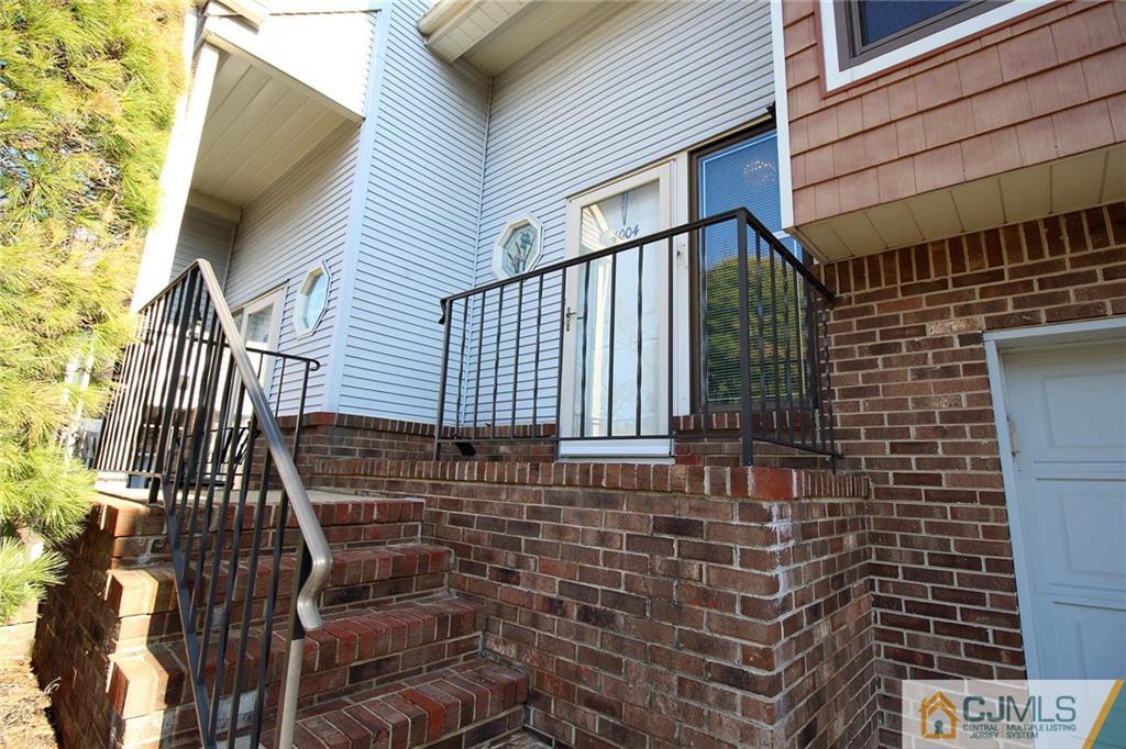 4004 Springbrook Drive Edison, NJ 08820 - Photo 3 of 25 a view of a brick house with many windows