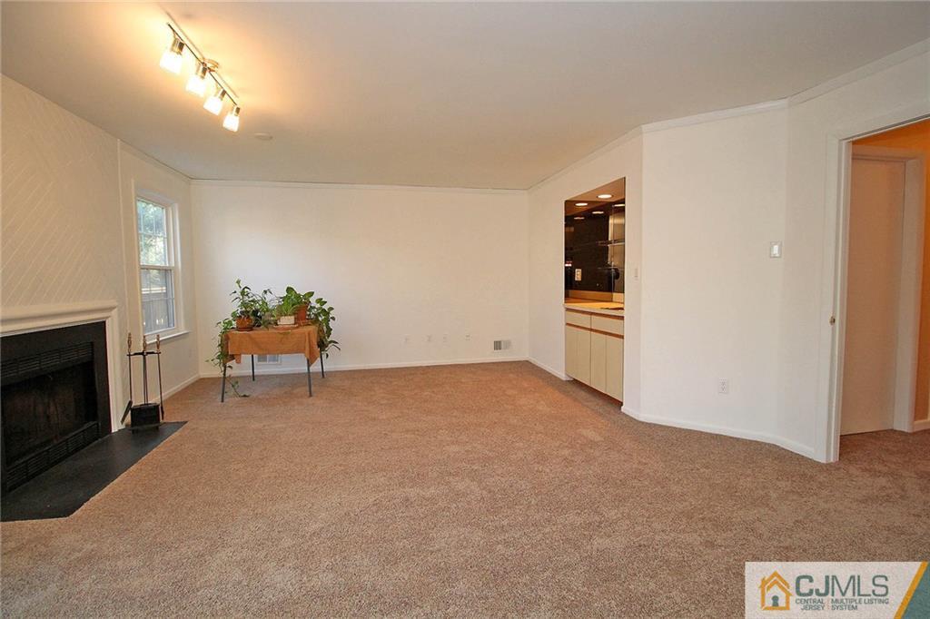 4004 Springbrook Drive Edison, NJ 08820 - Photo 22 of 25 a living room with furniture and a fireplace