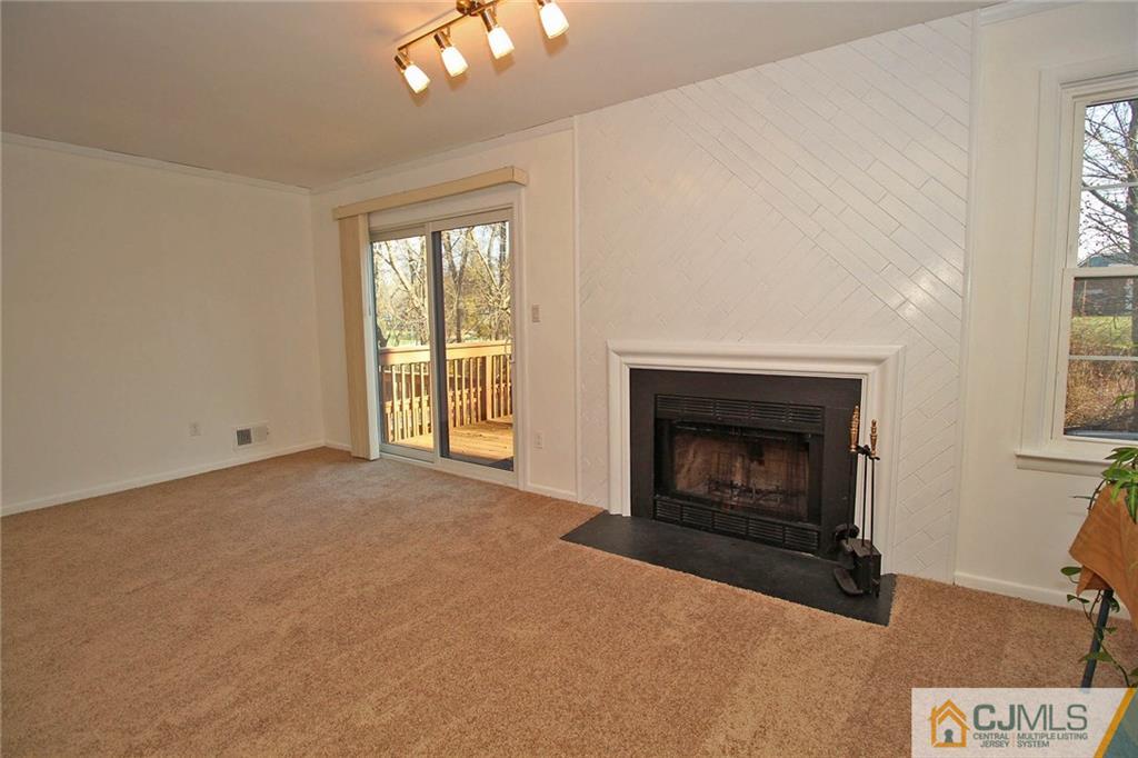 4004 Springbrook Drive Edison, NJ 08820 - Photo 23 of 25 a view of an empty room with a fireplace and a window
