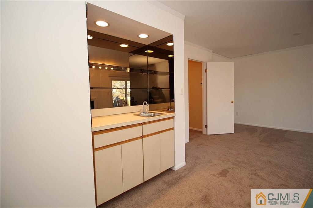 4004 Springbrook Drive Edison, NJ 08820 - Photo 24 of 25 a bathroom with a sink and a mirror