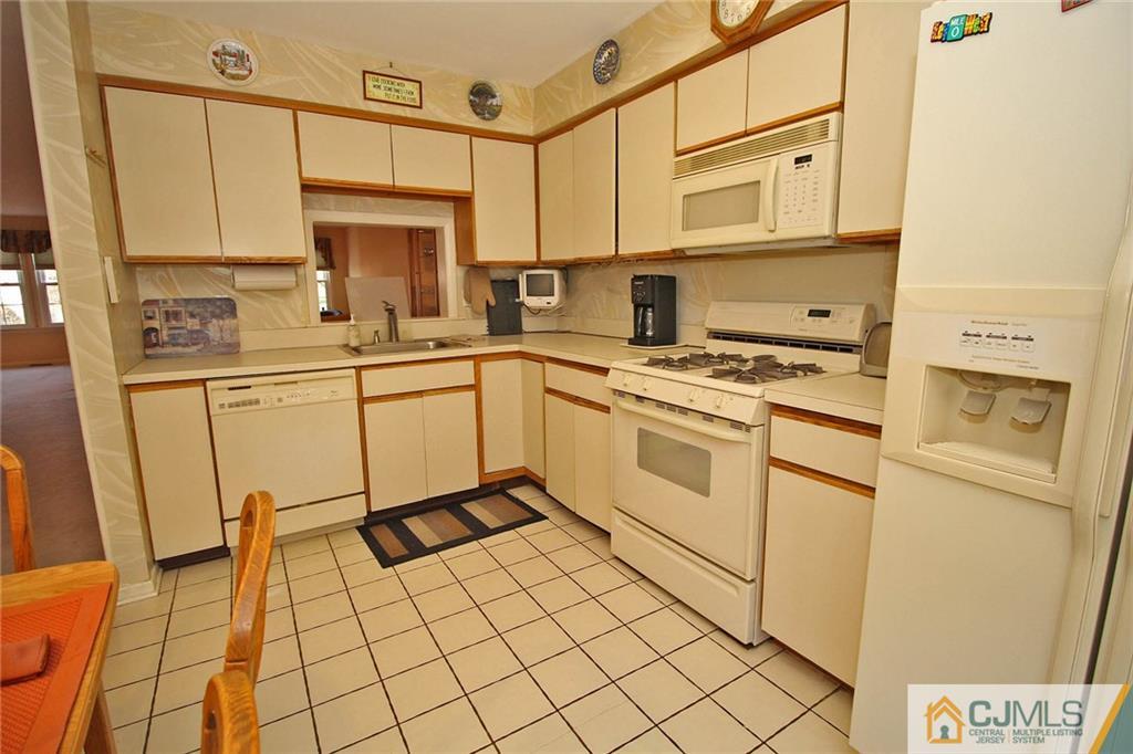 4004 Springbrook Drive Edison, NJ 08820 - Photo 10 of 25 a kitchen with stainless steel appliances a stove top oven