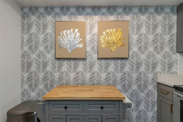 a room with a lamp and paintings on the wall