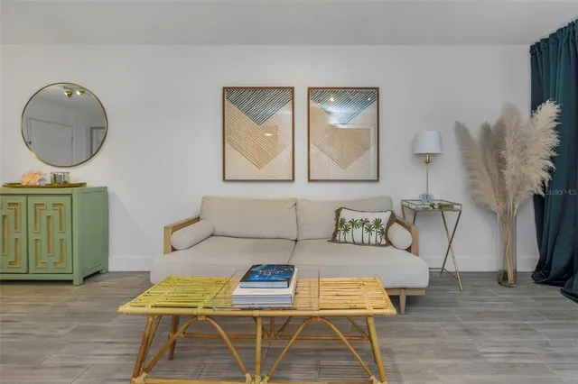 a living room with furniture and a mirror