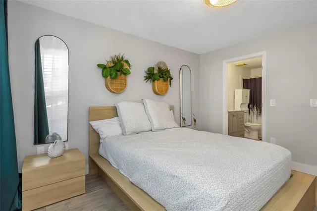 a bedroom with a bed and painting on the wall