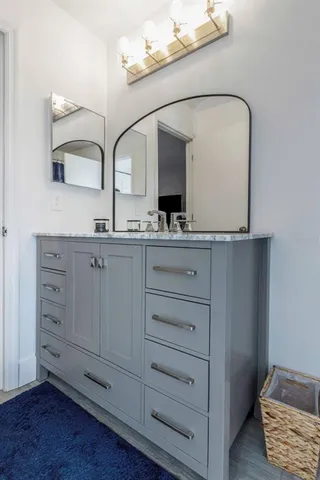 a bathroom with a double vanity sink and mirror