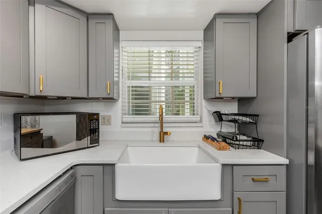 a kitchen with a sink and a microwave