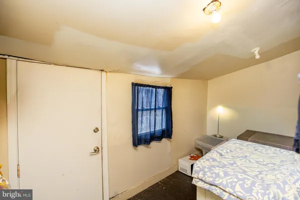 a bedroom with a bed and a lamp on the table
