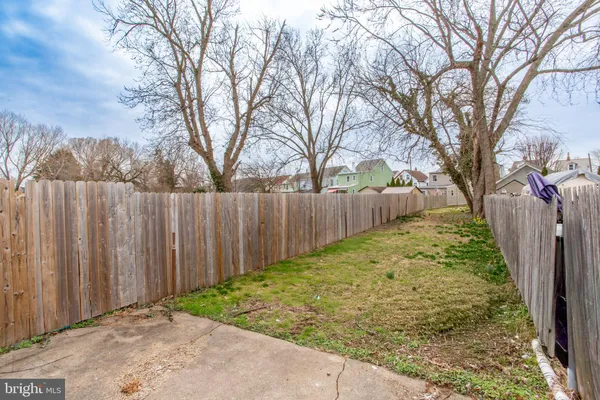a view of a backyard with wooden fence