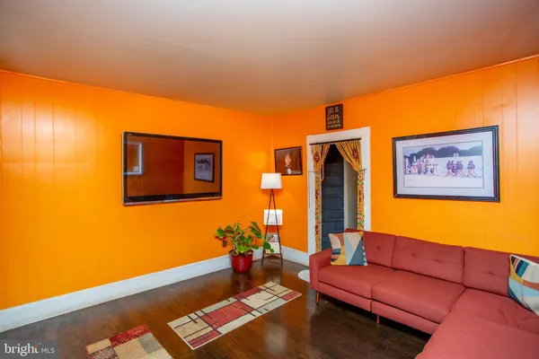 a living room with furniture and wall paintings