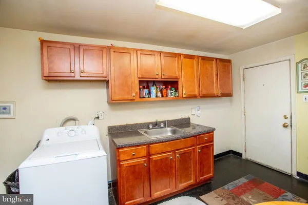 a utility room with two sink dryer and washer