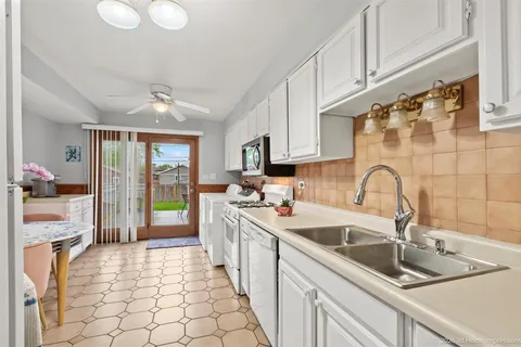 a kitchen with a sink cabinets and appliances
