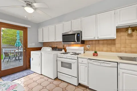 a view of cabinets a sink a washer and dryer