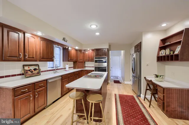 a kitchen that has a table chairs and wooden floor