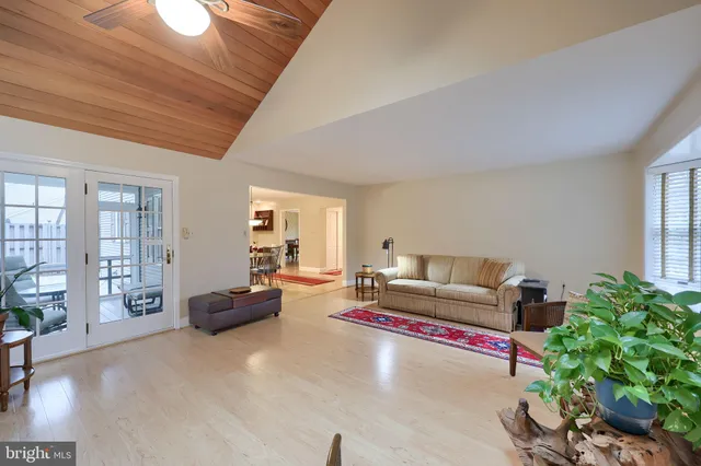 a living room with furniture rug and wooden floor