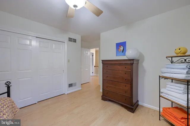 a bedroom with a bed and ceiling fan