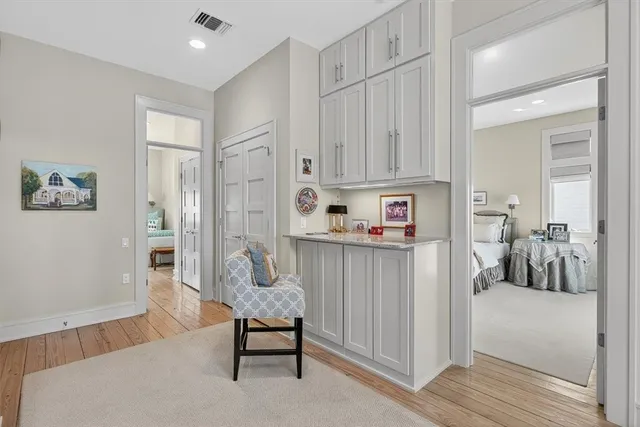 a spacious bedroom with a bed and a chandelier