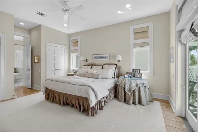 a bedroom with a bed a dresser and a painting