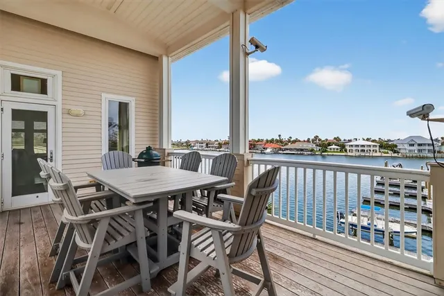 a view of a balcony dining table and chairs