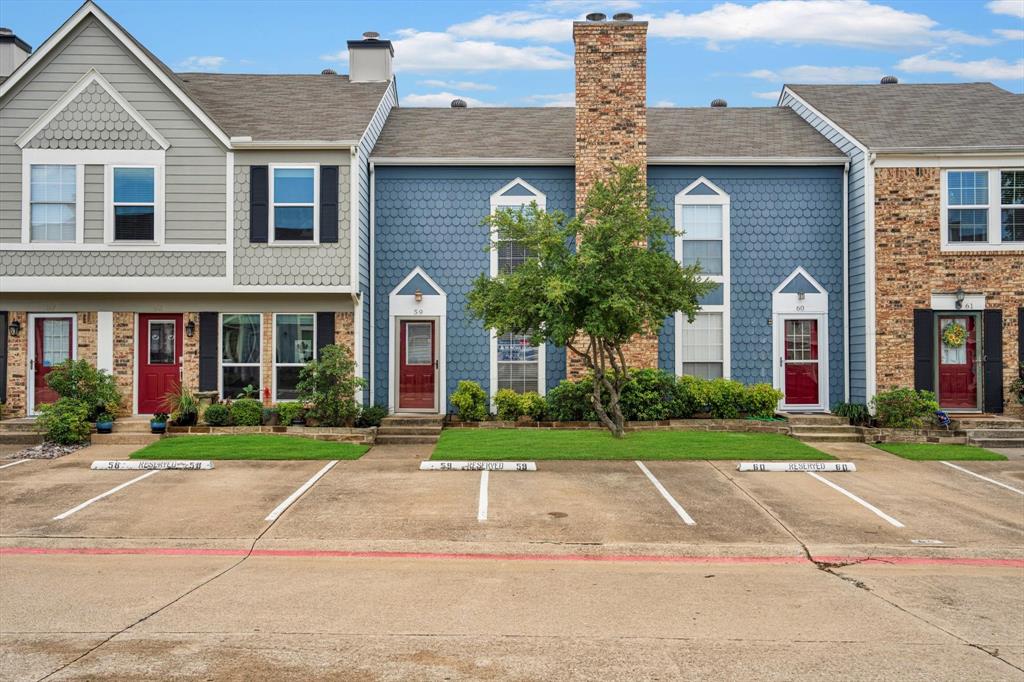 a front view of a house with a yard and plants