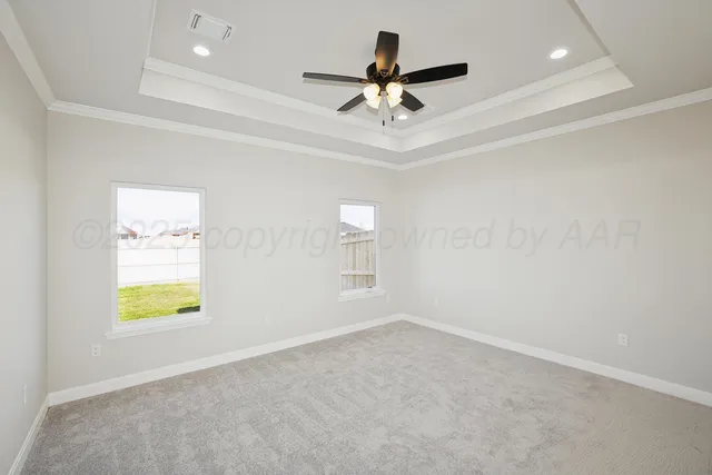 an empty room with a window and a ceiling fan