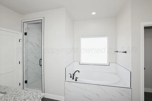 a bathroom with a bathtub and a shower