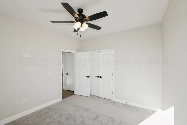 an empty room with a ceiling fan