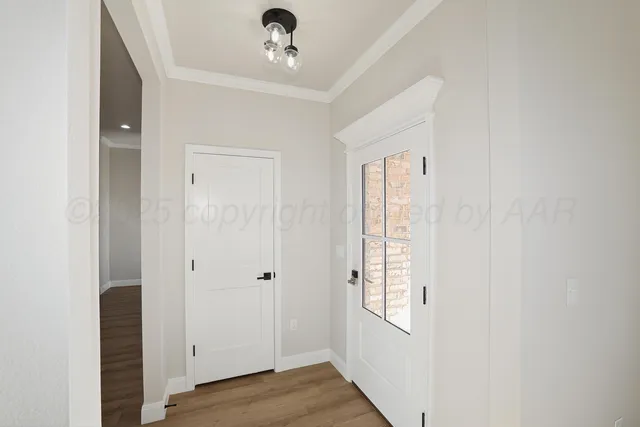 a view of an entryway with wooden floor