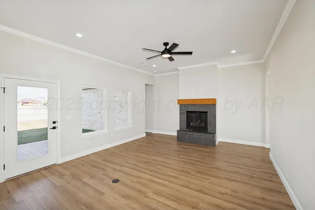 a view of an empty room with a fireplace and a window