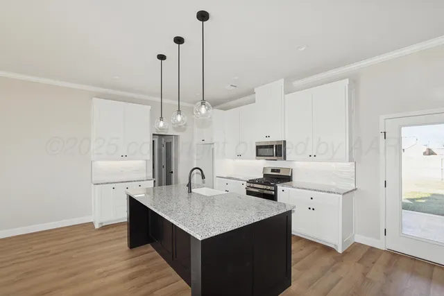 a kitchen with sink cabinets and wooden floor