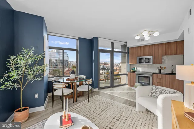 a kitchen with stainless steel appliances granite countertop a stove refrigerator and microwave