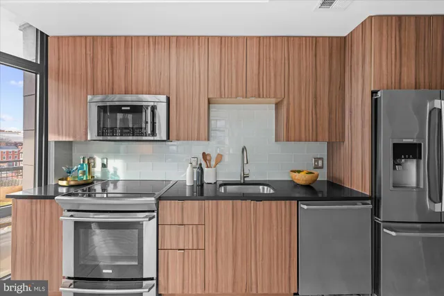 a living room with furniture a large window and chandelier