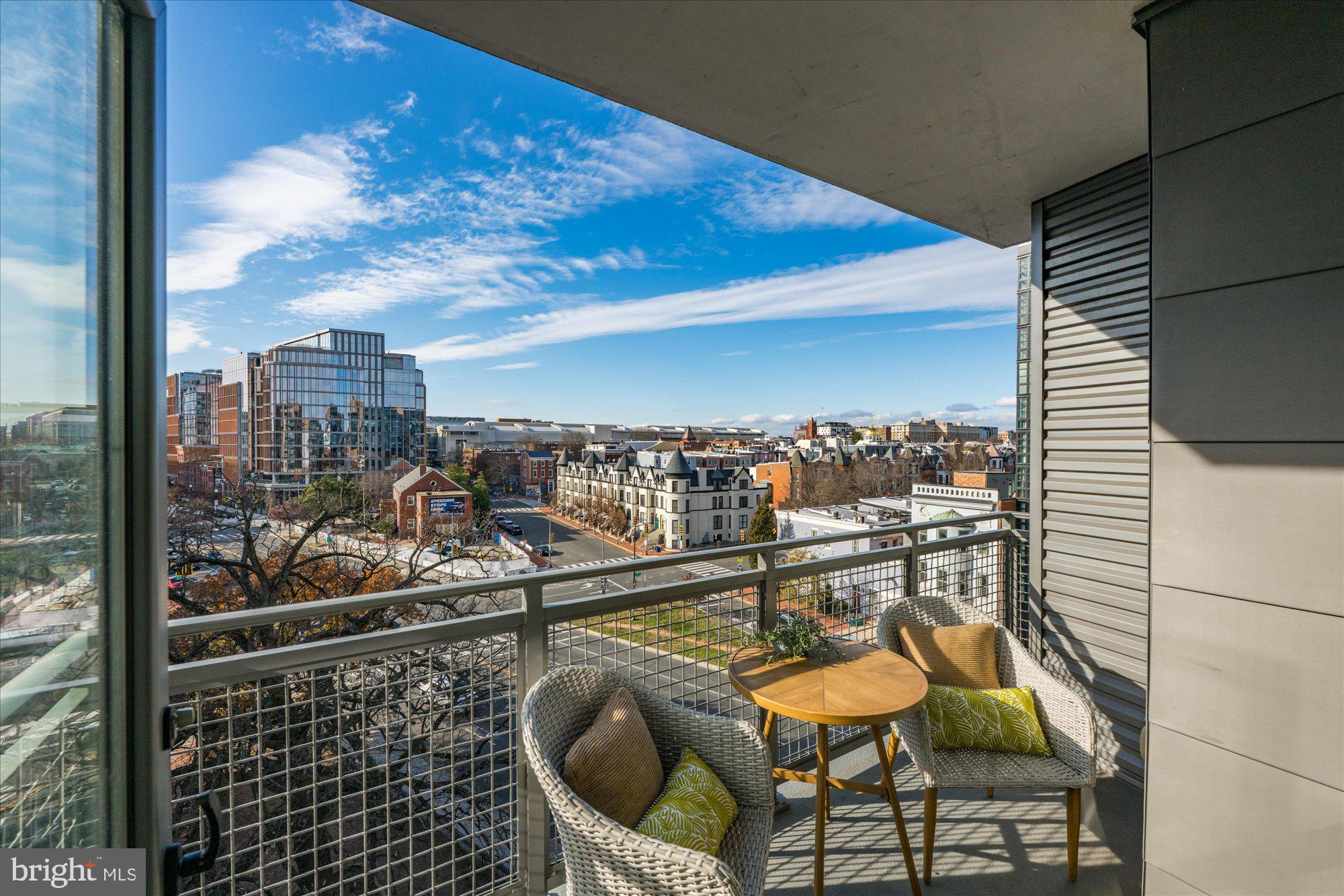 460 New York Avenue Northwest, Unit 504 Washington, DC 20001 - Photo 19 of 62 a view of a chairs and table in a balcony