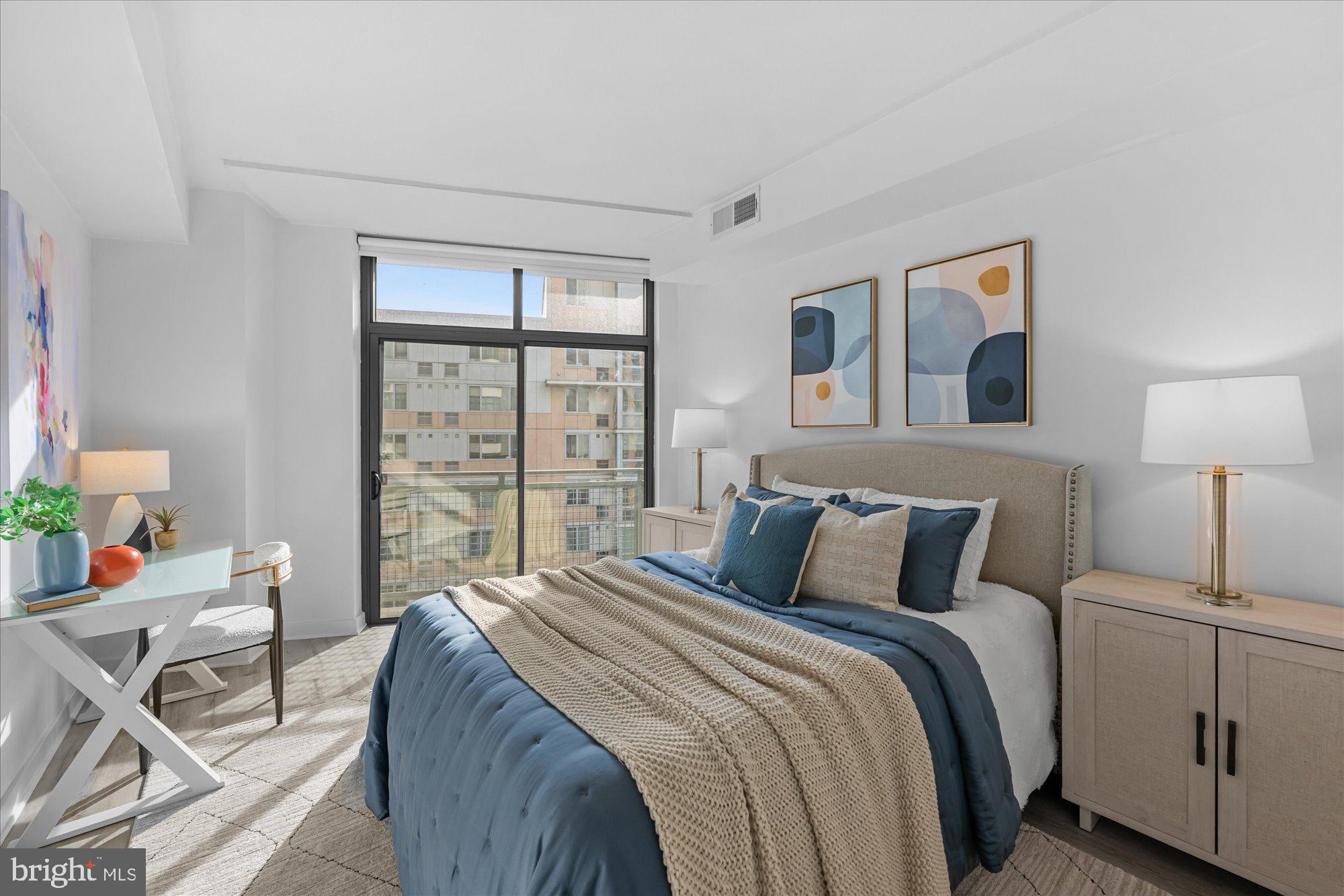 460 New York Avenue Northwest, Unit 504 Washington, DC 20001 - Photo 23 of 62 a bedroom with a bed and wooden floor