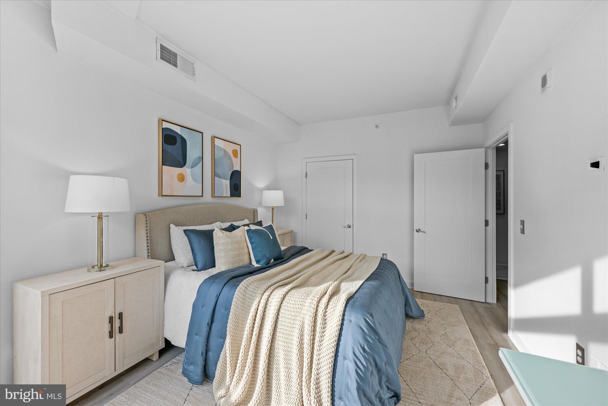 460 New York Avenue Northwest, Unit 504 Washington, DC 20001 - Photo 24 of 62 a bedroom with a bed and a night stand