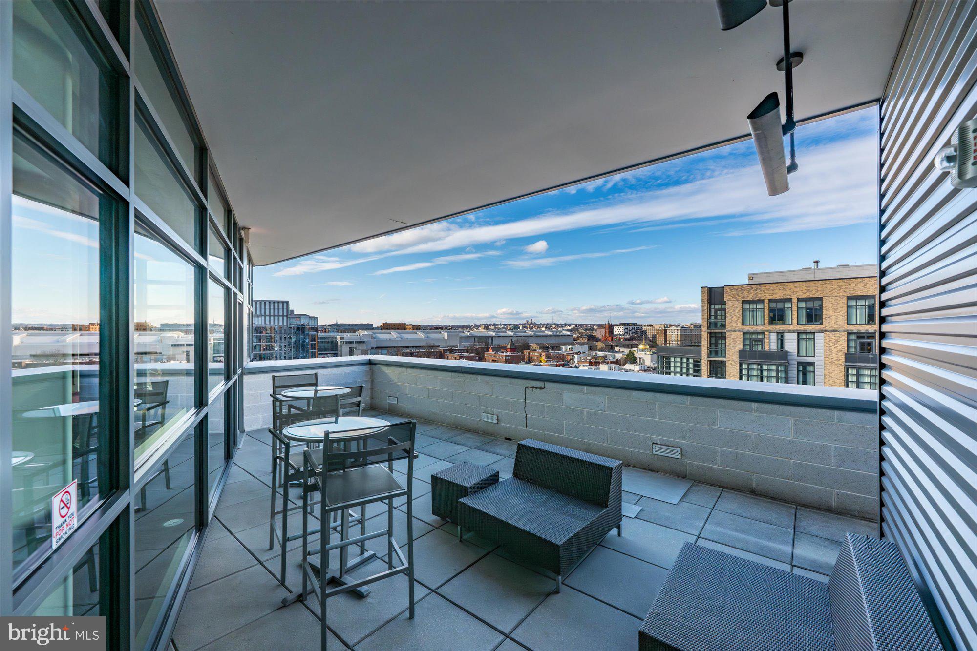460 New York Avenue Northwest, Unit 504 Washington, DC 20001 - Photo 39 of 62 a terrace with outdoor seating and city view