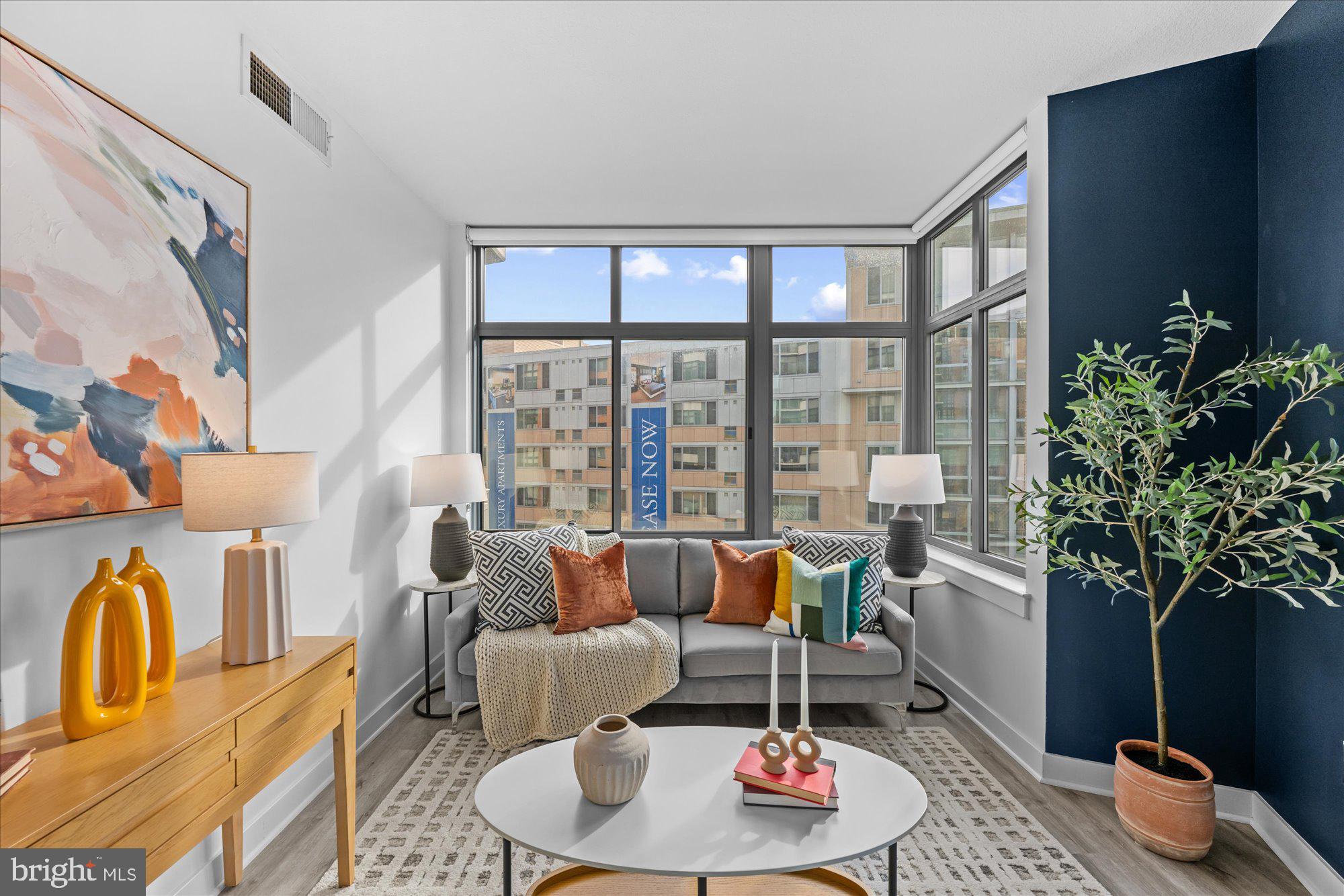 460 New York Avenue Northwest, Unit 504 Washington, DC 20001 - Photo 10 of 62 a living room with furniture and a potted plant