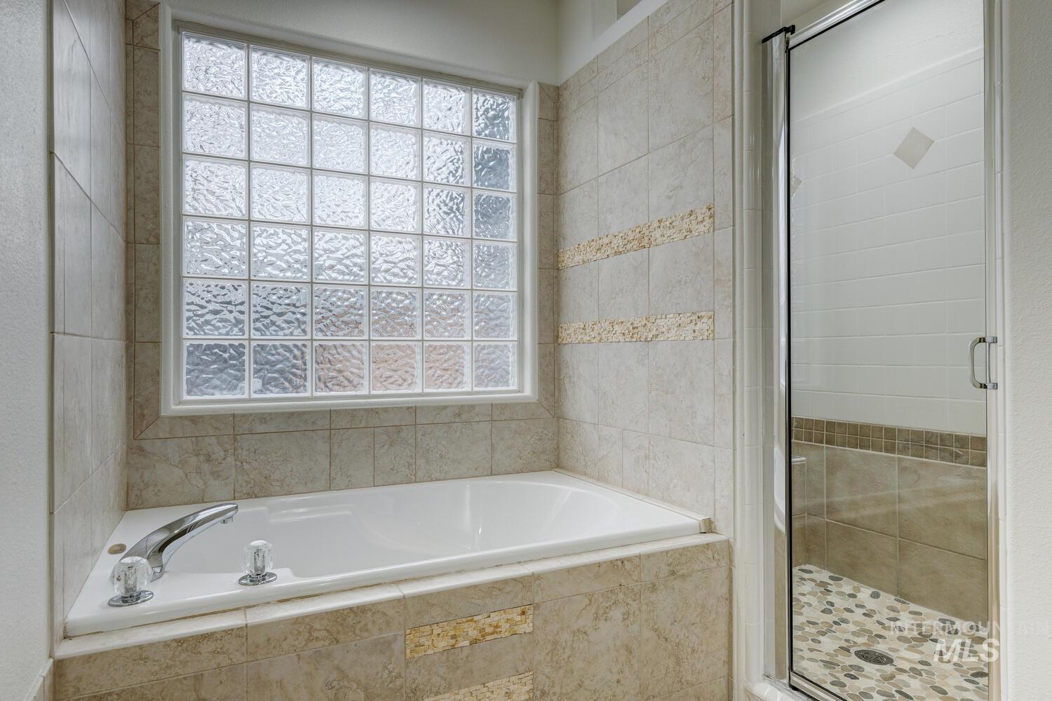 1168 North Pinnacle Way Eagle, ID 83616 - Photo 23 of 32 Bathroom featuring a stall shower and a bath