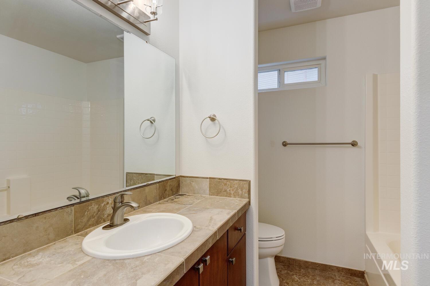 1168 North Pinnacle Way Eagle, ID 83616 - Photo 26 of 32 Full bathroom with vanity and shower / bath combination with curtain