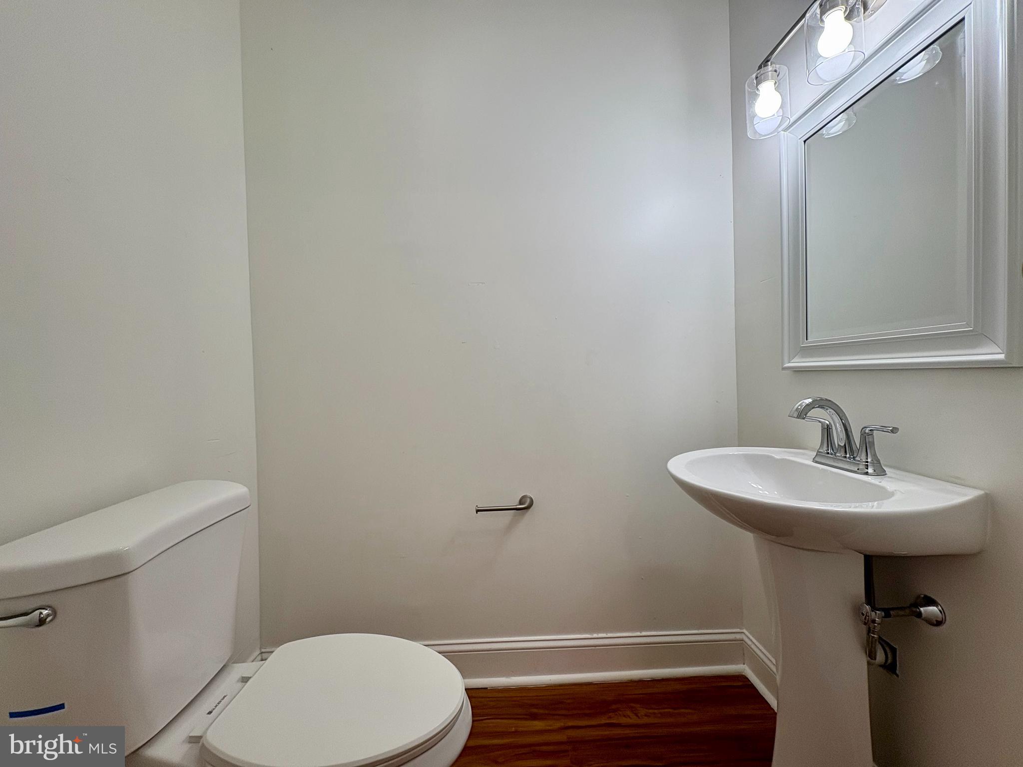 758 Fremont Street Lancaster, PA 17603 - Photo 12 of 20 a bathroom with a sink a toilet and a mirror